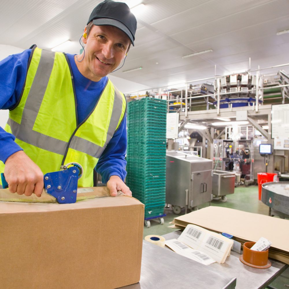 portrait-of-a-smiling-worker-taping-box-in-a-food-2026-01-11-09-59-19-utc